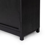 Millie Panel and Glass Door Cabinet Drifted Matte Black Lower Corner Detail 235949-001